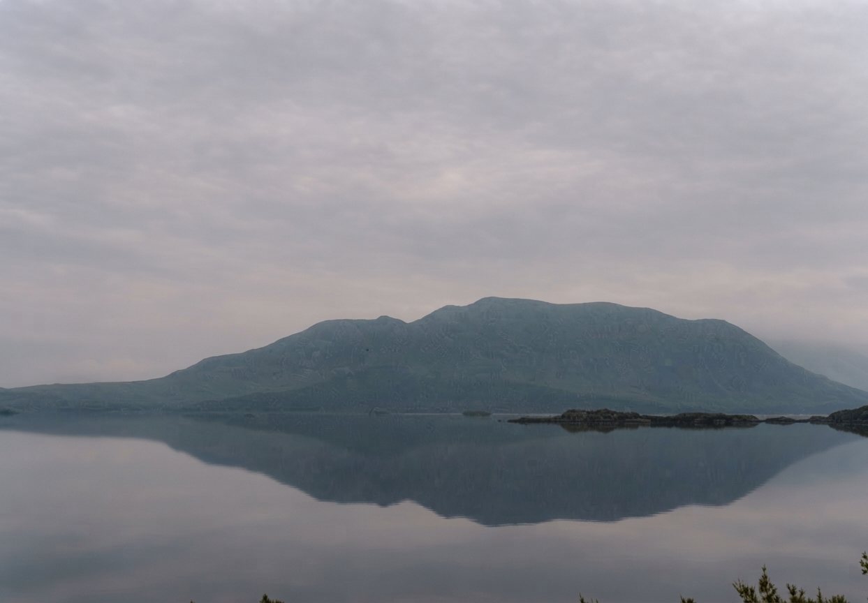 Still lake reflecting the hills