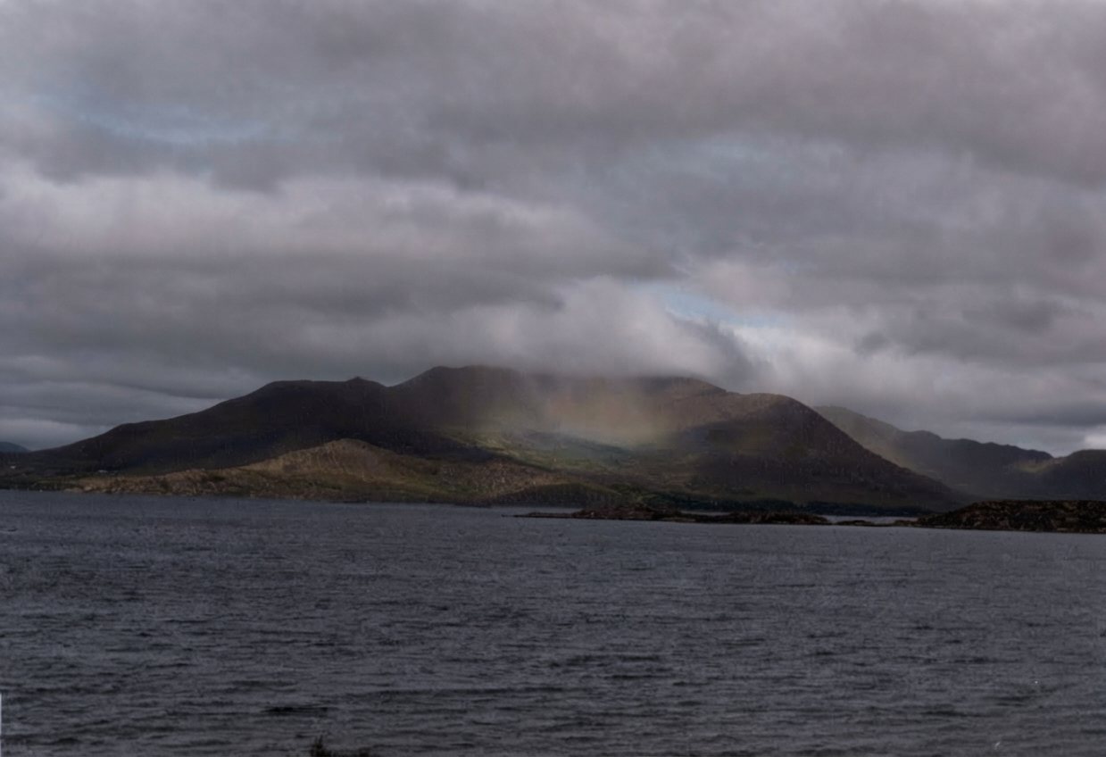 Misty hill across the water