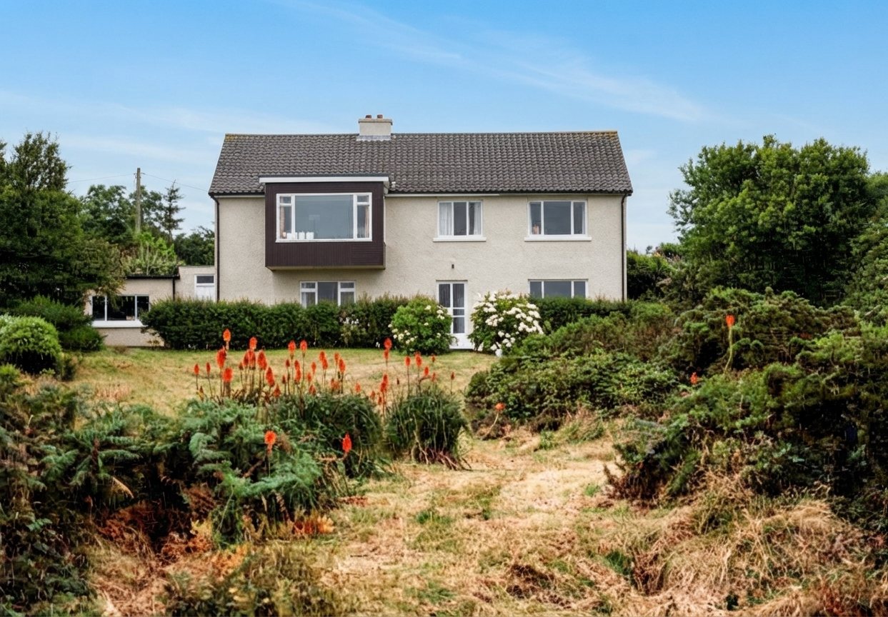 House seen from the garden with red flowers in foreground