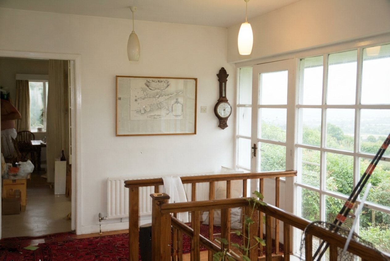 Bright landing with staircase and French doors