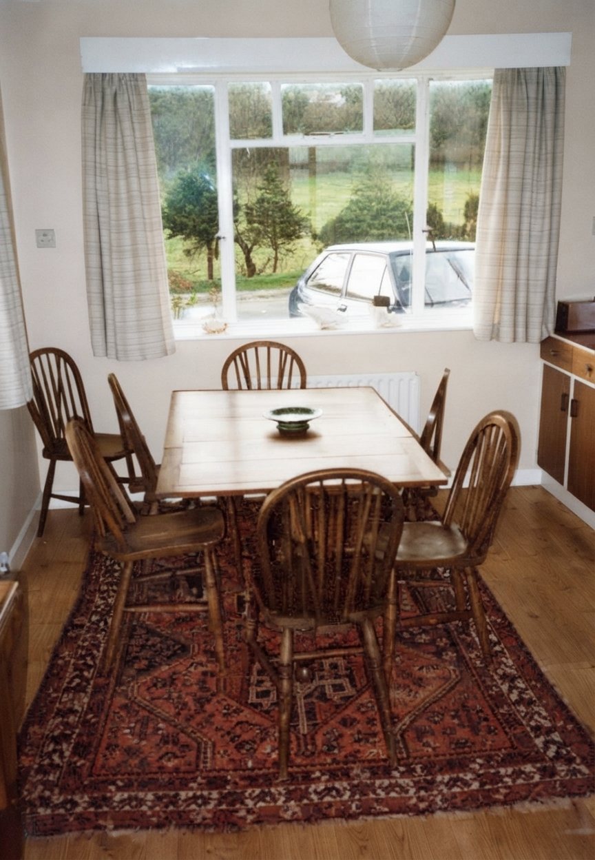Dining table set beneath a bright window